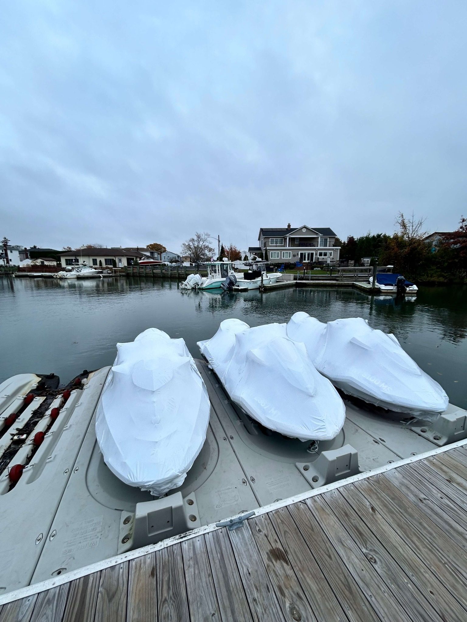 Three jet skis winterized and shrink wrapped on Long Island dock — Jetmore Jetski